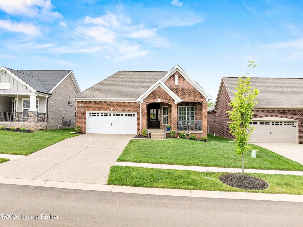 5716 Ruby Falls Dr, Prospect, KY 40059 - view of front of property with covered porch, driveway, brick siding, a garage, and a front yard
