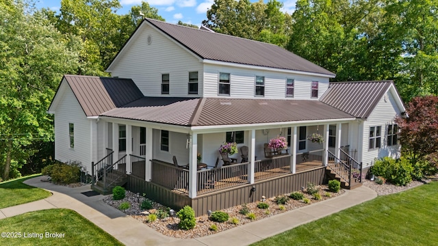 684 Cheslon Rd, Munfordville, KY 42765 - view of front of home with metal roof, a porch, a standing seam roof, and a front yard