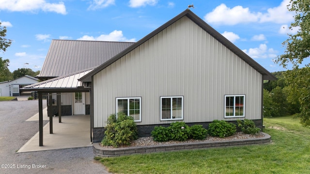 684 Cheslon Rd, Munfordville, KY 42765 - view of side of home featuring a yard, a patio, metal roof, and board and batten siding