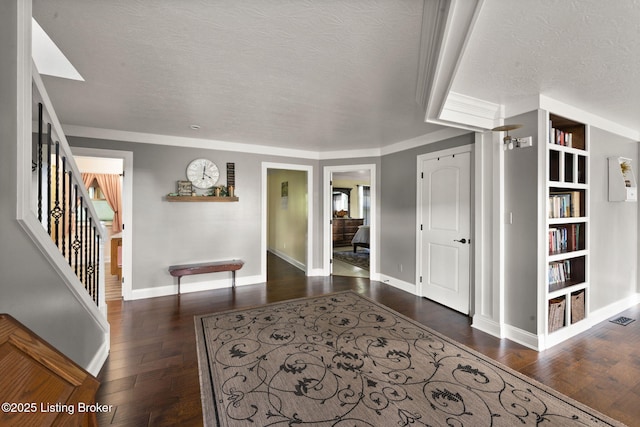 684 Cheslon Rd, Munfordville, KY 42765 - corridor with a textured ceiling, wood finished floors, baseboards, built in shelves, and stairs