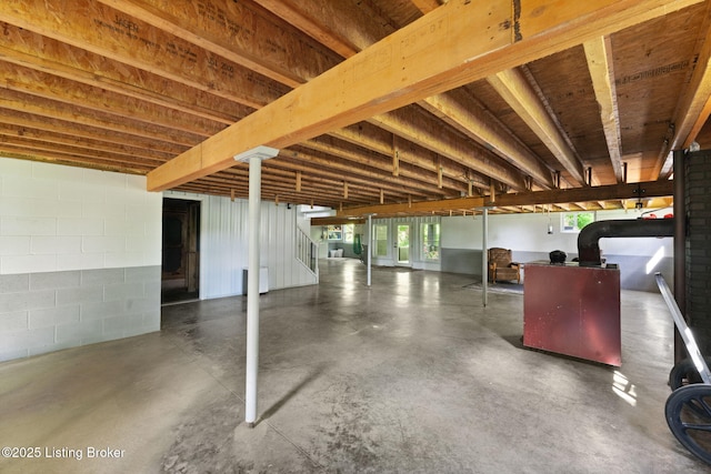 684 Cheslon Rd, Munfordville, KY 42765 - miscellaneous room with concrete flooring, stairway, and concrete block wall