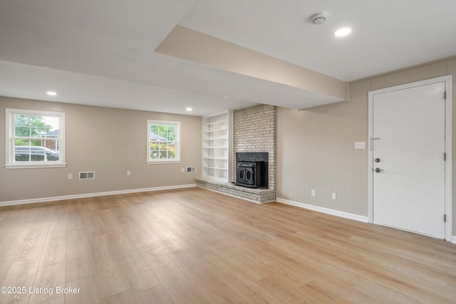 9707 Gateway Dr, Louisville, KY 40299 - unfurnished living room featuring light wood-type flooring, built in shelves, baseboards, plenty of natural light, and recessed lighting