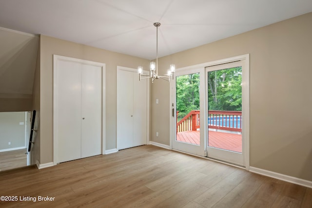 9707 Gateway Dr, Louisville, KY 40299 - unfurnished dining area featuring wood finished floors, a chandelier, and baseboards