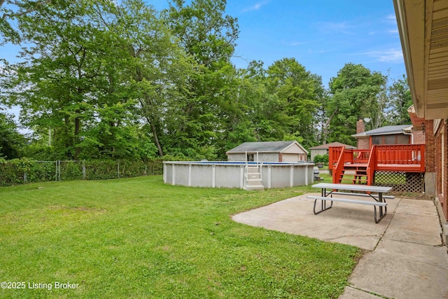9707 Gateway Dr, Louisville, KY 40299 - view of yard with a wooden deck, an outdoor pool, and a patio