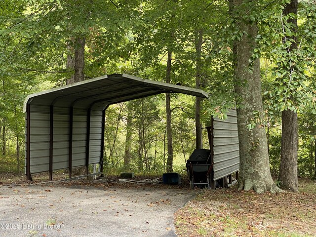 682 Hornback Mill Ln, Leitchfield, KY 42754 - view of outdoor structure with a detached carport and a wooded view
