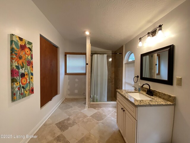 682 Hornback Mill Ln, Leitchfield, KY 42754 - bathroom with a tile shower, vanity, lofted ceiling, baseboards, and a textured ceiling