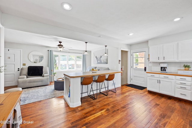 7513 Merlyn Cir, Louisville, KY 40214 - kitchen featuring open floor plan, plenty of natural light, dark wood finished floors, white cabinets, and recessed lighting