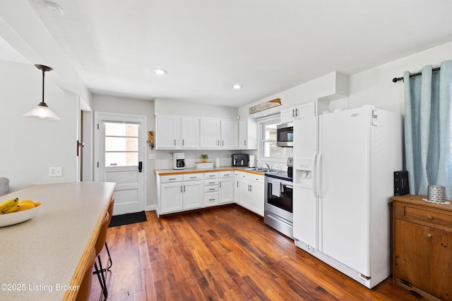 7513 Merlyn Cir, Louisville, KY 40214 - kitchen with stainless steel appliances, white cabinetry, dark wood finished floors, light countertops, and recessed lighting