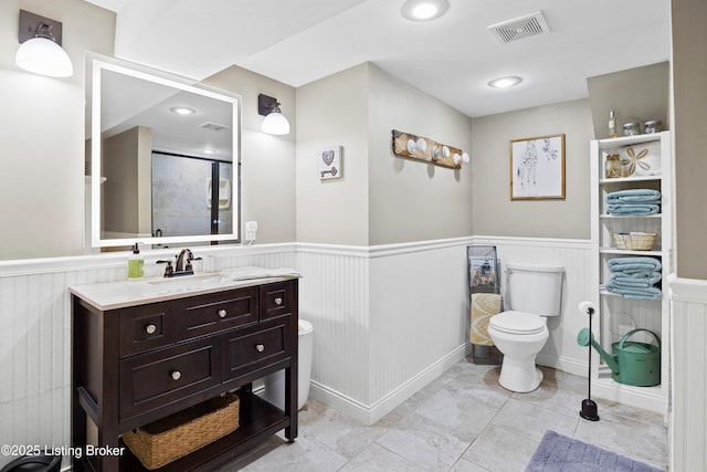 7513 Merlyn Cir, Louisville, KY 40214 - bathroom featuring toilet, wainscoting, vanity, and a shower