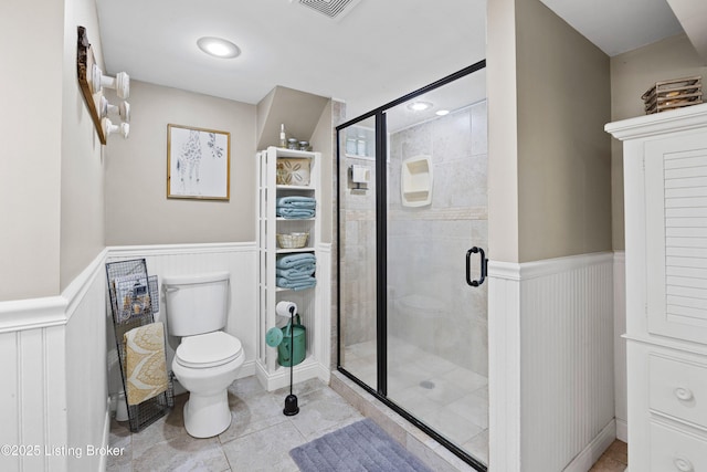 7513 Merlyn Cir, Louisville, KY 40214 - full bathroom with toilet, a wainscoted wall, a stall shower, tile patterned flooring, and a decorative wall