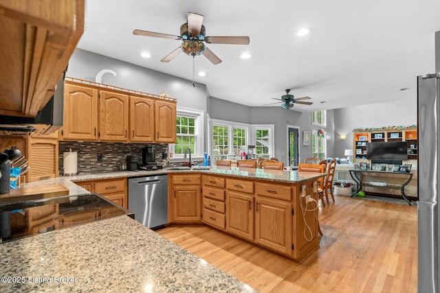 4011 Serendipity Ln, Louisville, KY 40272 - kitchen featuring stainless steel appliances, a ceiling fan, a sink, light wood-style flooring, and backsplash