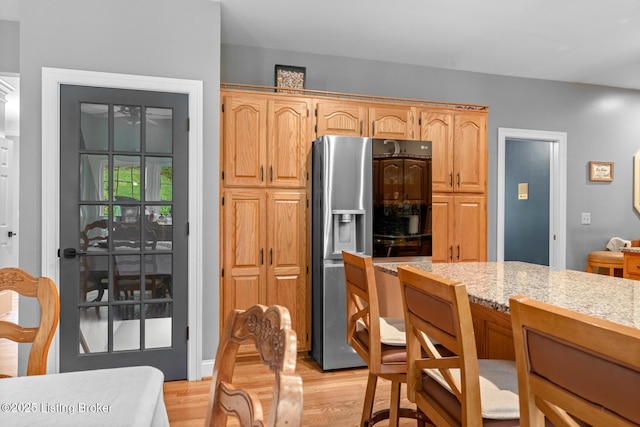 4011 Serendipity Ln, Louisville, KY 40272 - kitchen with fridge with ice dispenser, light wood-style flooring, and light stone countertops