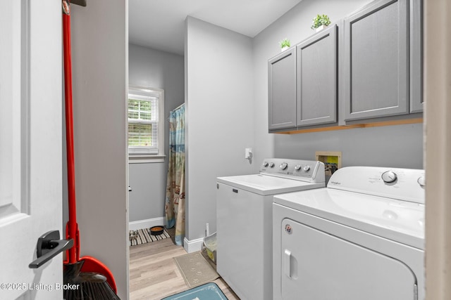 4011 Serendipity Ln, Louisville, KY 40272 - washroom with cabinet space, washer and clothes dryer, light wood-style floors, and baseboards