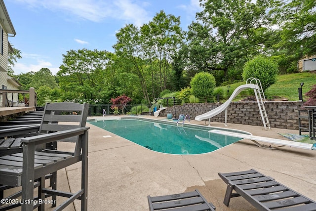 4011 Serendipity Ln, Louisville, KY 40272 - view of swimming pool with a diving board, a patio area, a water slide, and view of wooded area