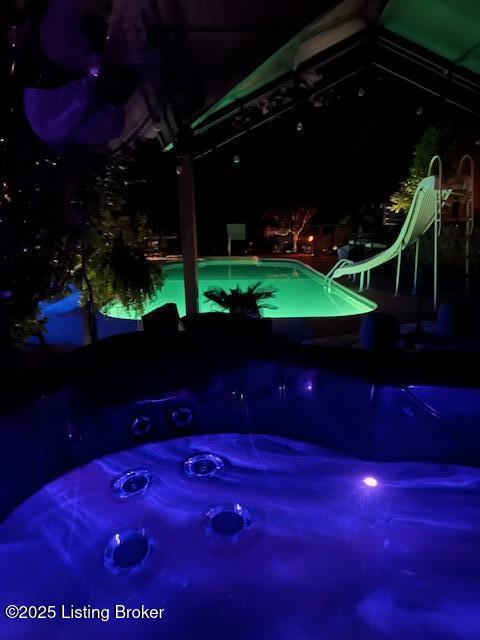 4011 Serendipity Ln, Louisville, KY 40272 - pool at twilight with a water slide, a jacuzzi, and an outdoor pool