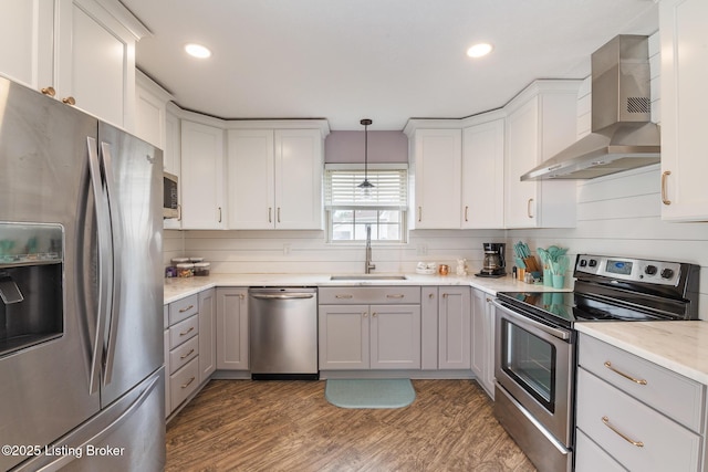 5704 Bartview Ct, Louisville, KY 40229 - kitchen featuring stainless steel appliances, wall chimney range hood, a sink, dark wood-style flooring, and white cabinetry