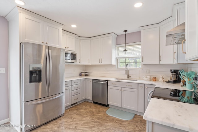 5704 Bartview Ct, Louisville, KY 40229 - kitchen with stainless steel appliances, a sink, custom range hood, light wood-type flooring, and white cabinetry