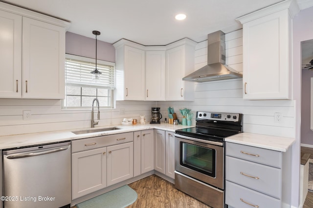 5704 Bartview Ct, Louisville, KY 40229 - kitchen featuring stainless steel appliances, wall chimney range hood, a sink, light wood finished floors, and light countertops