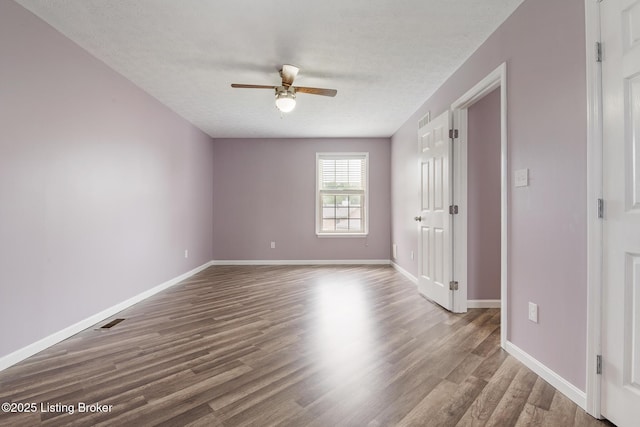 5704 Bartview Ct, Louisville, KY 40229 - empty room with a ceiling fan, wood finished floors, baseboards, and a textured ceiling