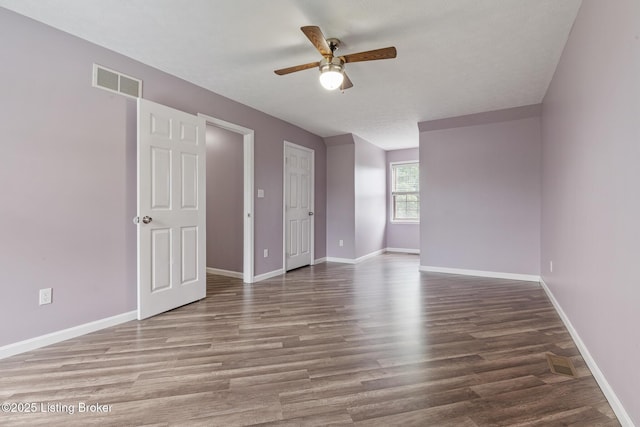 5704 Bartview Ct, Louisville, KY 40229 - unfurnished room with a ceiling fan, wood finished floors, and baseboards