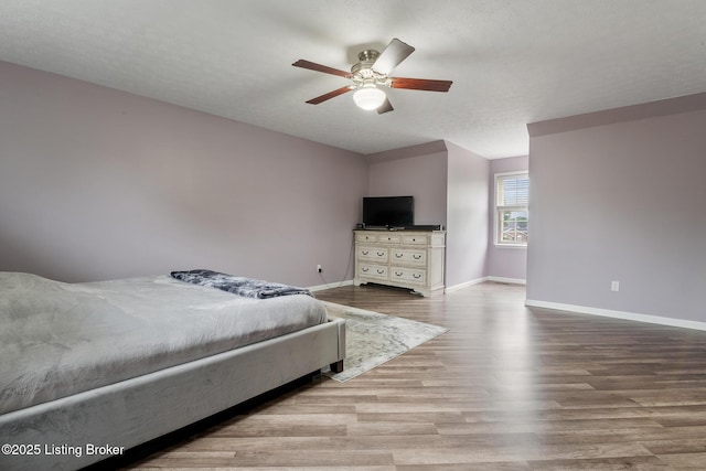 5704 Bartview Ct, Louisville, KY 40229 - bedroom with baseboards, wood finished floors, and ceiling fan