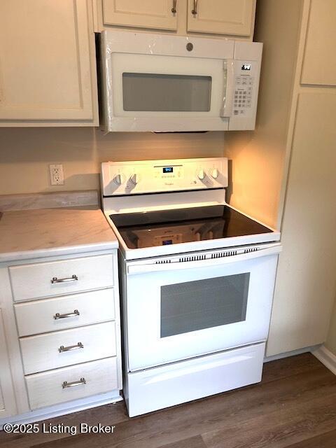 638 Gheens Ave, Louisville, KY 40214 - kitchen with white appliances, light countertops, and dark wood-style floors
