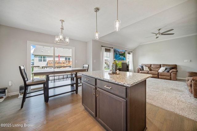 10905 Hidden Trail Ct, Louisville, KY 40229 - kitchen featuring dark brown cabinets, light wood finished floors, hanging light fixtures, a ceiling fan, and vaulted ceiling