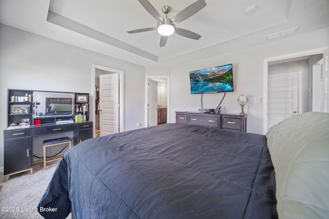 10905 Hidden Trail Ct, Louisville, KY 40229 - carpeted bedroom featuring a tray ceiling, a ceiling fan, and connected bathroom