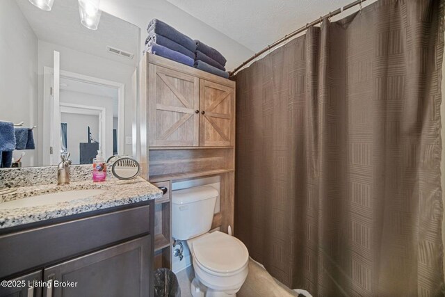 10905 Hidden Trail Ct, Louisville, KY 40229 - bathroom with toilet, vanity, and curtained shower