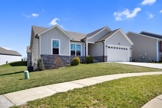 10905 Hidden Trail Ct, Louisville, KY 40229 - view of front of property featuring board and batten siding, a garage, stone siding, and a front yard