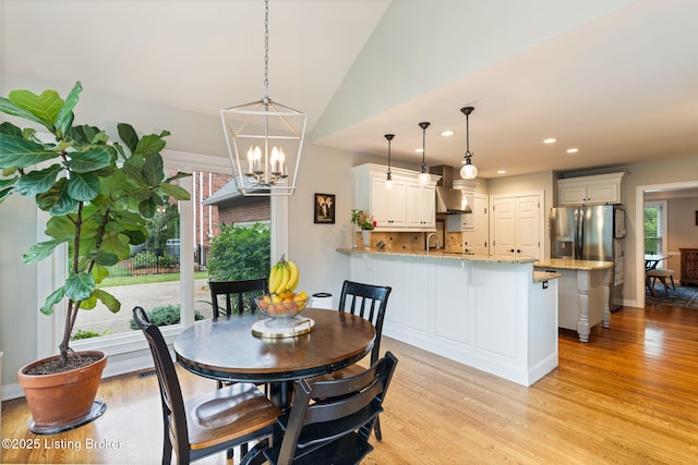 3908 Keal Run Way, Louisville, KY 40241 - dining room with light wood-style flooring, a chandelier, recessed lighting, lofted ceiling, and baseboards