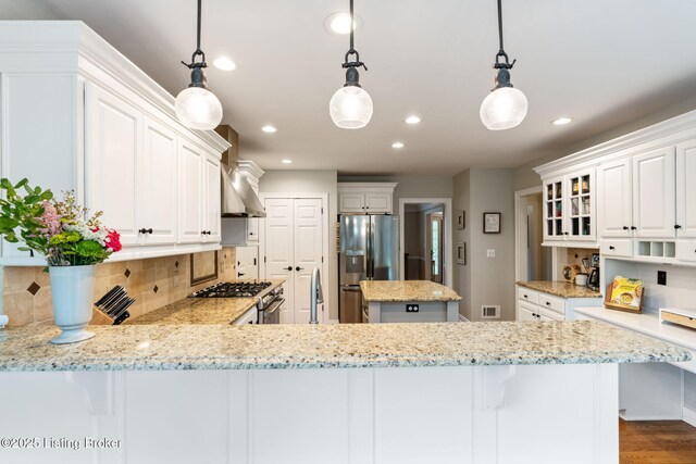 3908 Keal Run Way, Louisville, KY 40241 - kitchen featuring stainless steel appliances, wall chimney exhaust hood, recessed lighting, backsplash, and light stone counters
