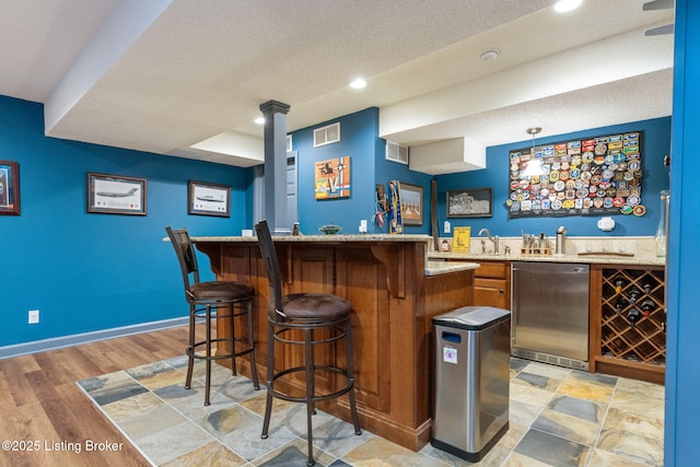 3908 Keal Run Way, Louisville, KY 40241 - indoor wet bar featuring stainless steel dishwasher, recessed lighting, baseboards, a textured ceiling, and light wood finished floors