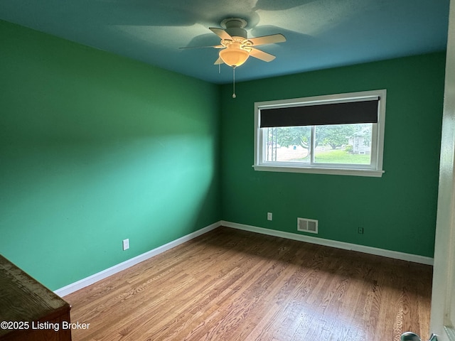 7005 Shareith Dr, Louisville, KY 40228 - spare room with wood finished floors, ceiling fan, and baseboards