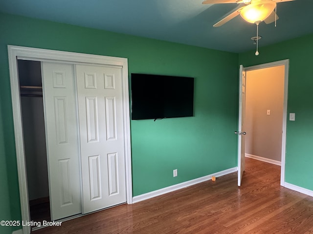 7005 Shareith Dr, Louisville, KY 40228 - unfurnished bedroom with wood finished floors, baseboards, a closet, and ceiling fan