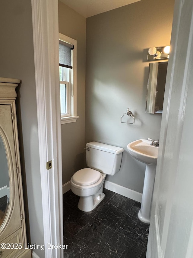7005 Shareith Dr, Louisville, KY 40228 - bathroom featuring toilet, baseboards, and marble look tiles