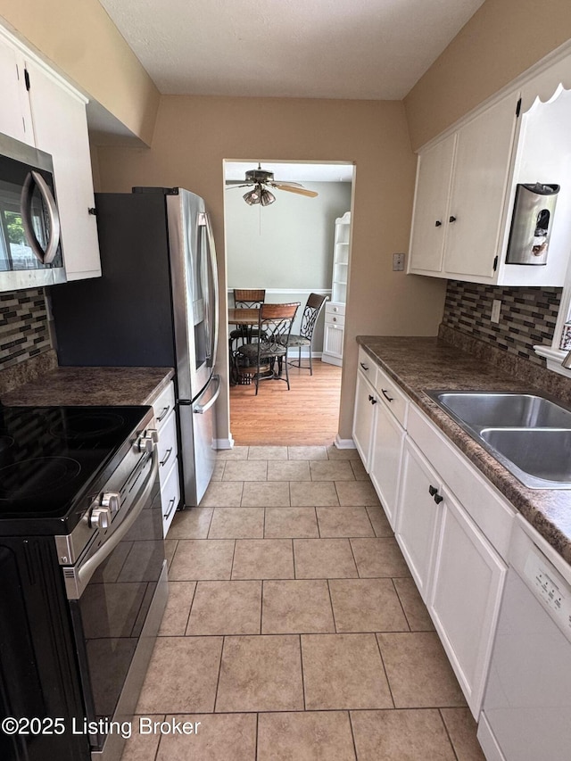 7005 Shareith Dr, Louisville, KY 40228 - kitchen featuring stainless steel appliances, a sink, a ceiling fan, and decorative backsplash
