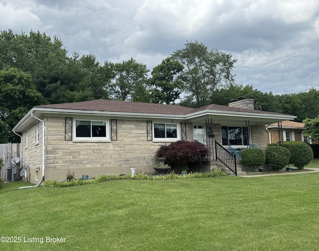 7005 Shareith Dr, Louisville, KY 40228 - view of front of home featuring stone siding, a front yard, a chimney, covered porch, and central AC unit