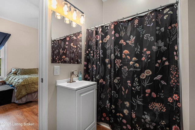 920 Lydia St, Louisville, KY 40217 - full bathroom featuring vanity, wood finished floors, a shower with curtain, and connected bathroom