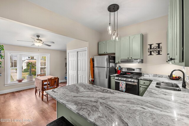 920 Lydia St, Louisville, KY 40217 - kitchen with stainless steel appliances, range hood, green cabinetry, and a peninsula
