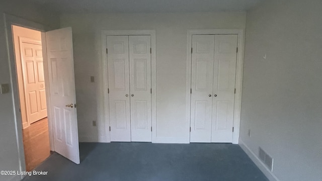123 Westwind Trl, Bardstown, KY 40004 - unfurnished bedroom with two closets, baseboards, and dark colored carpet