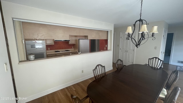 123 Westwind Trl, Bardstown, KY 40004 - dining area featuring a chandelier, wood finished floors, and baseboards