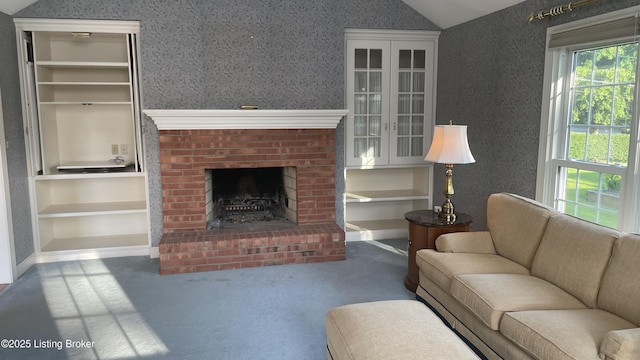 123 Westwind Trl, Bardstown, KY 40004 - living area featuring a brick fireplace, vaulted ceiling, carpet flooring, and built in shelves