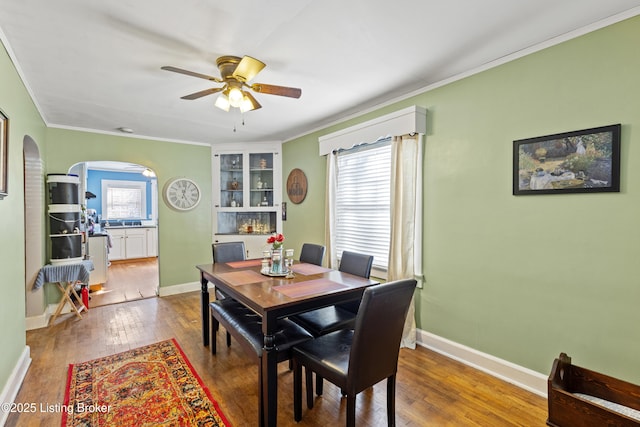 715 Woodland Ave, Frankfort, KY 40601 - dining room with arched walkways, ornamental molding, ceiling fan, hardwood / wood-style floors, and baseboards