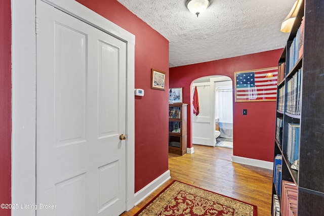 715 Woodland Ave, Frankfort, KY 40601 - entryway featuring arched walkways, baseboards, hardwood / wood-style floors, and a textured ceiling
