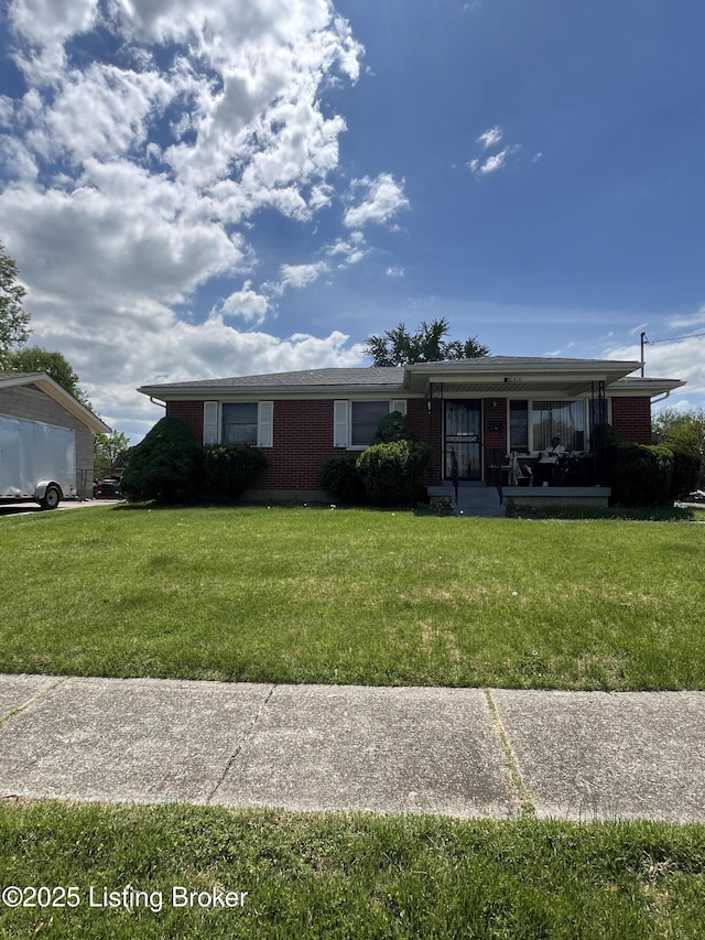 2514 Mcgee Dr, Louisville, KY 40216 - single story home with a front lawn, brick siding, and a porch