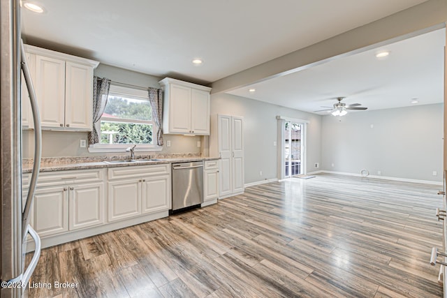1507 Glenrock Rd, Louisville, KY 40216 - kitchen featuring stainless steel dishwasher, a sink, light wood finished floors, white cabinetry, and refrigerator