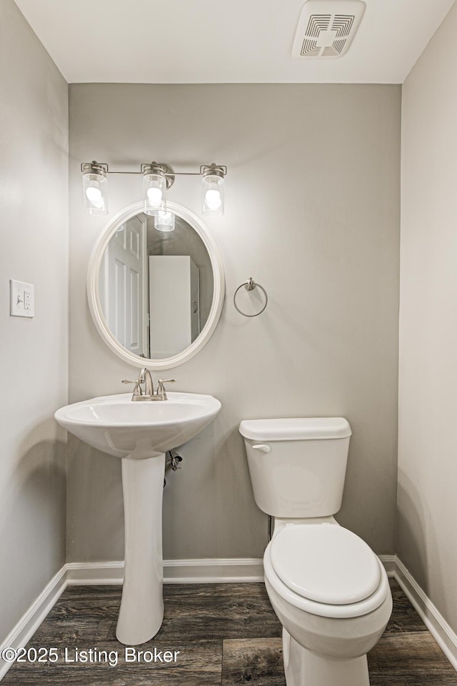 1507 Glenrock Rd, Louisville, KY 40216 - bathroom with baseboards, wood finished floors, and toilet