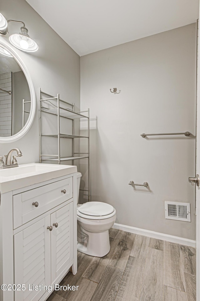 1507 Glenrock Rd, Louisville, KY 40216 - bathroom featuring toilet, wood finished floors, vanity, and baseboards