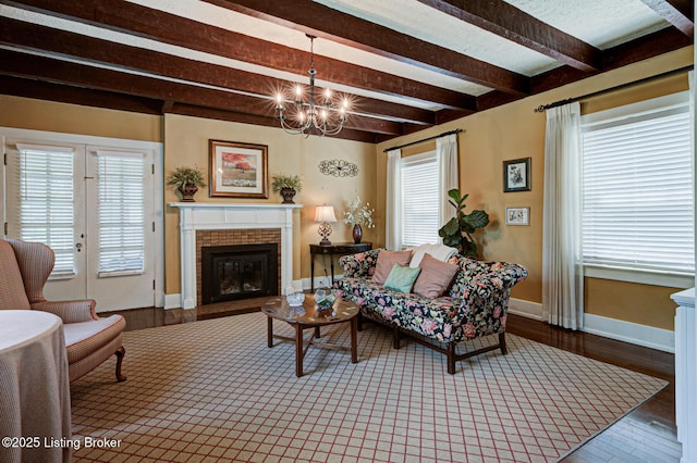 916 Audubon Pkwy, Audubon Park, KY 40213 - living room with beamed ceiling, a fireplace, plenty of natural light, wood finished floors, and baseboards